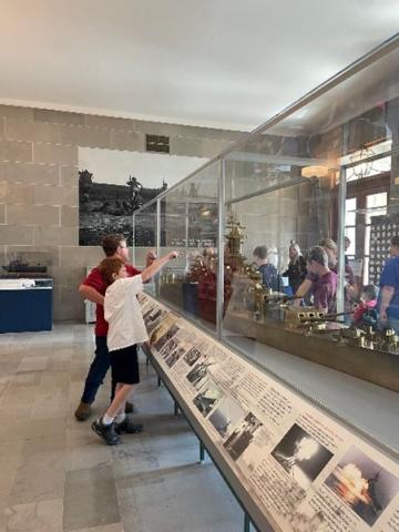 Students view war-themed exhibits inside the Capitol