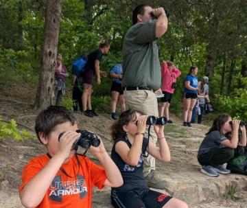 Students looking through binoculars