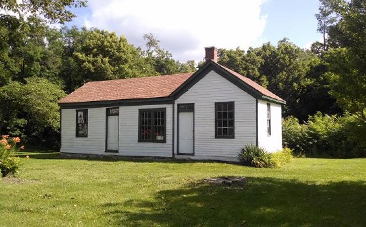 A small white house with a red roof