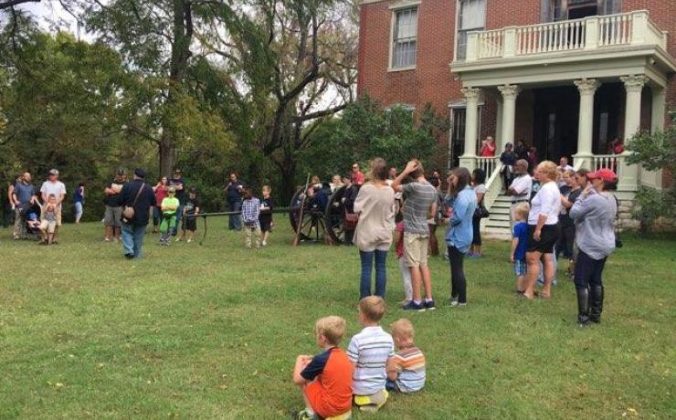 People gathered outside a brick building