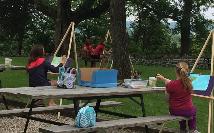 People painting in a field