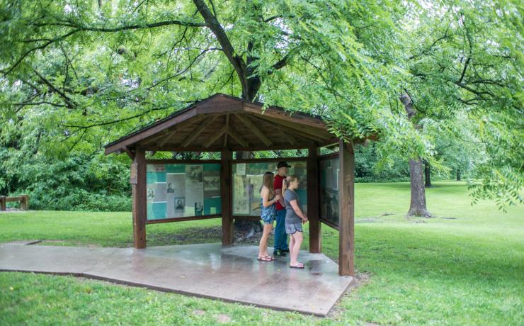 A family looking at informational boards at the Battle of Carthage Historical Site