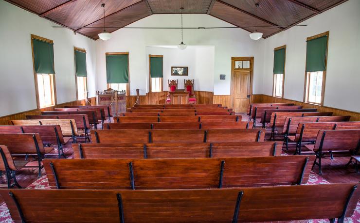 A civil-war era church with red benches and floors