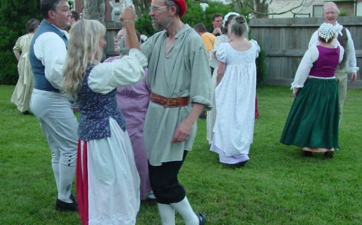 A group of historical re-enactors dancing