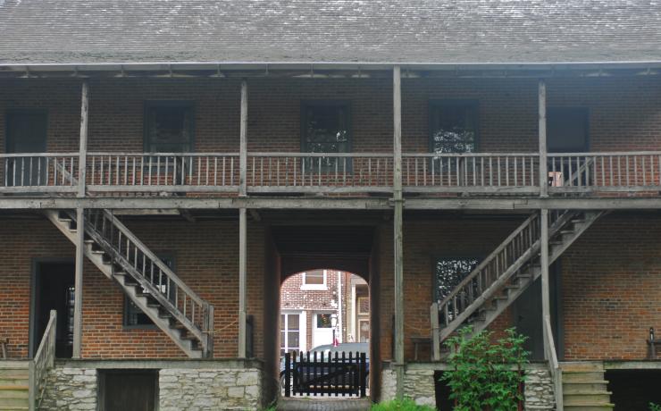 A brick building with a wooden balcony