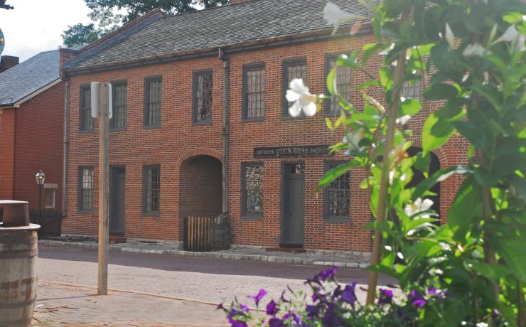 An old brick store with a &quot;dry goods and hardware&quot; sign