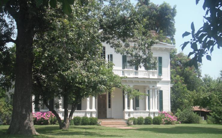 A white building behind trees