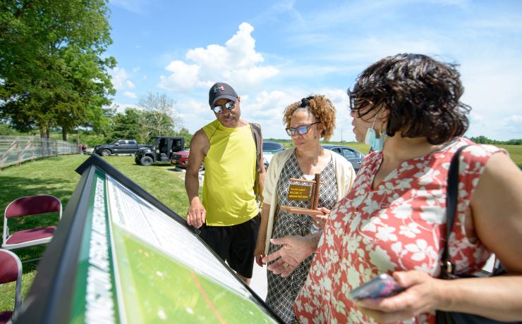 People gathered around an infograph