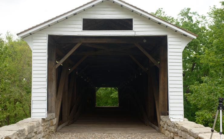 Entrance to a white covered bridge