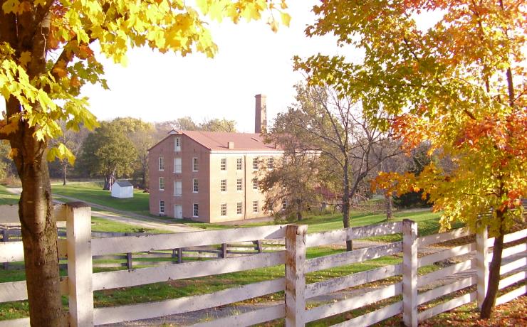 A brick building, as seen from behind a fence