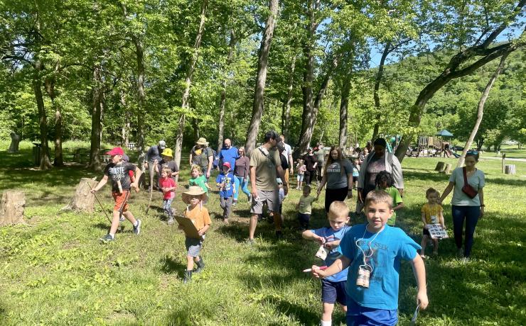 Children and adults walking through a field