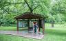 A family looking at informational boards at the Battle of Carthage Historical Site