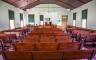 A civil-war era church with red benches and floors