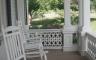 A white rocking chair on a porch