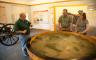 A park ranger showing a model of Missouri fields to two people