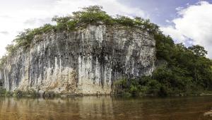Panoramic image of a cliffside by a river