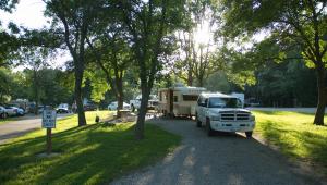 A camper set up beside a picnic table