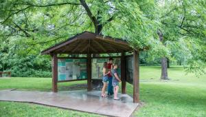 A family looking at informational boards at the Battle of Carthage Historical Site