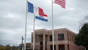 Outside of the Bruce R. Watkins Historical Culture Center with the Kansas City, Missouri, and United States flags on display