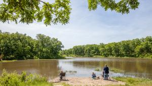 People sitting on the edge of a river