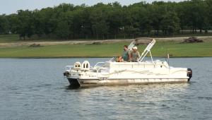 Three people in a boat on a lake