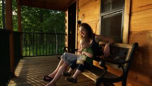 A person sitting on a bench with a child