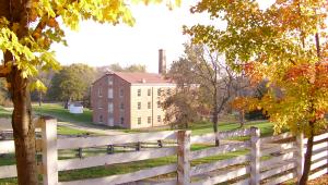 A brick building, as seen from behind a fence
