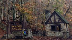 Sam A. Baker gate entrance with park sign and rock structure.
