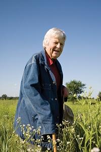 Pat Jones standing among some wildflowers