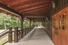 a wedding taking place in the rustic lodge with wood ceiling and rock fireplace