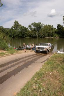 a truck unloading a boat at the boat ramp