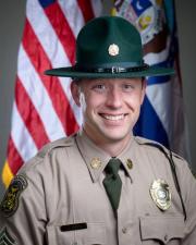 Rangers Reid Johnson standing in-front of a flag