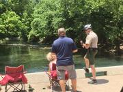Ranger on Bicycle talking with fisherman