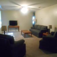 living room with a couch and two chairs in the lake house