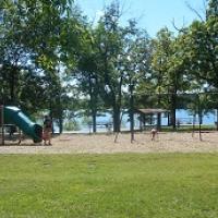 playground equipment with a slide and monkey bars and a swing set